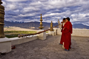Monks blow horns for the first morning prayer